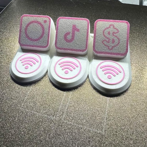 Drie 3D geprinte standjes met het logo van een sociaal netwerk erop